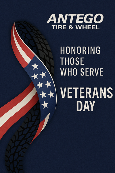 Veterans Day tribute by Antego Tire & Wheel: a ribbon blending the American flag with tire tread on a navy background with Honoring Those Who Serve.